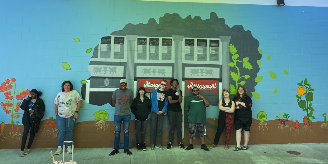 TGS public art class students completed a mural on the exterior wall of the staff lounge at the Marzetti Co. 